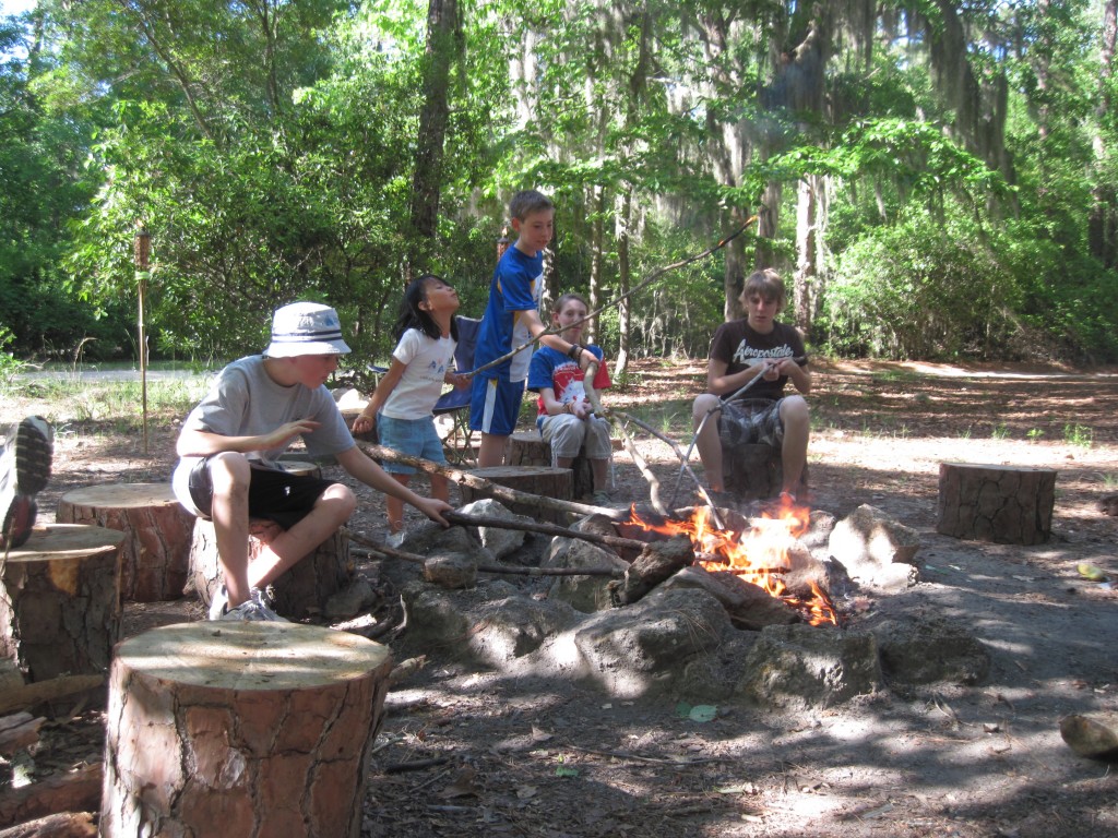 family friendly camping -- shows kids around a campfire
