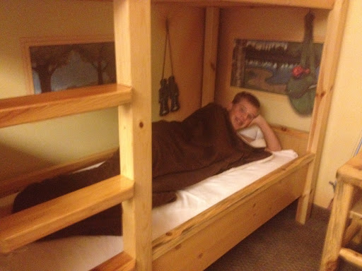 Great Wolf Lodge teen in a bunk bed, better than sharing with his sibliing.