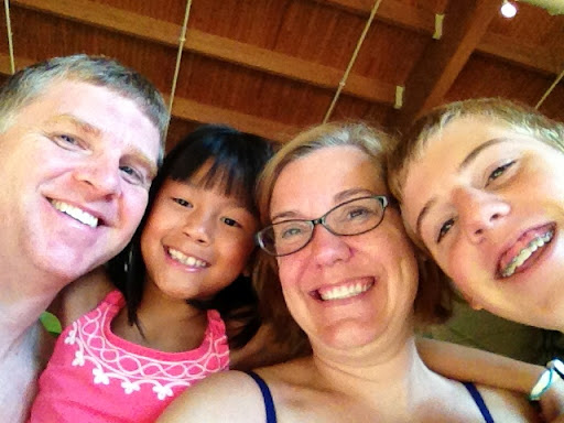 A family of four, smiling at Great Wolf Lodge NC.