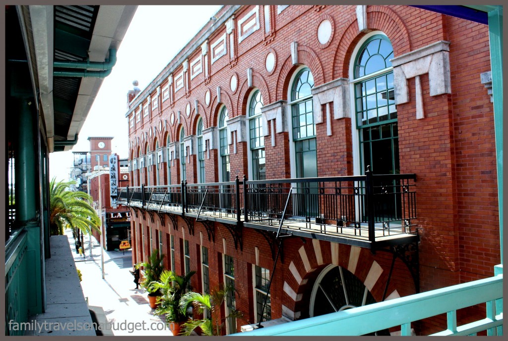 Architecture in Centro Ybor and palm trees along the street.