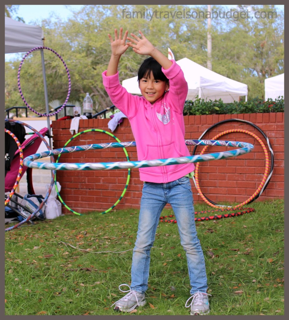 Our daughter testing the hula hoops for sale at the Ybor City Saturday Market.