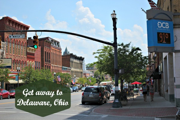 Words "Get away to Delaware, Ohio" with the downtown streetscape behind.