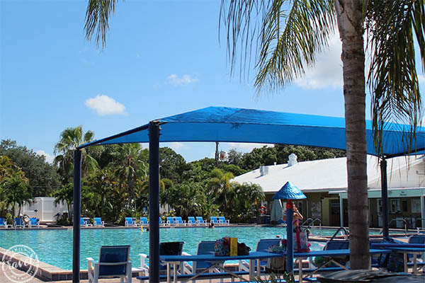 Outdoor pool with lounge chairs and sun shade covers at the Sun Outdoors Sarasota RV park
