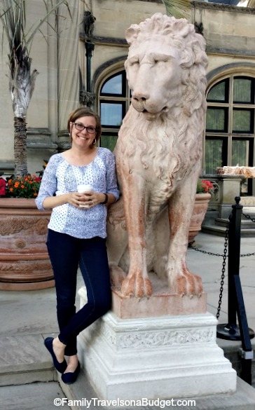 Standing next to a lion at the front entrance of the Biltmore House waiting for our tour time to enter.