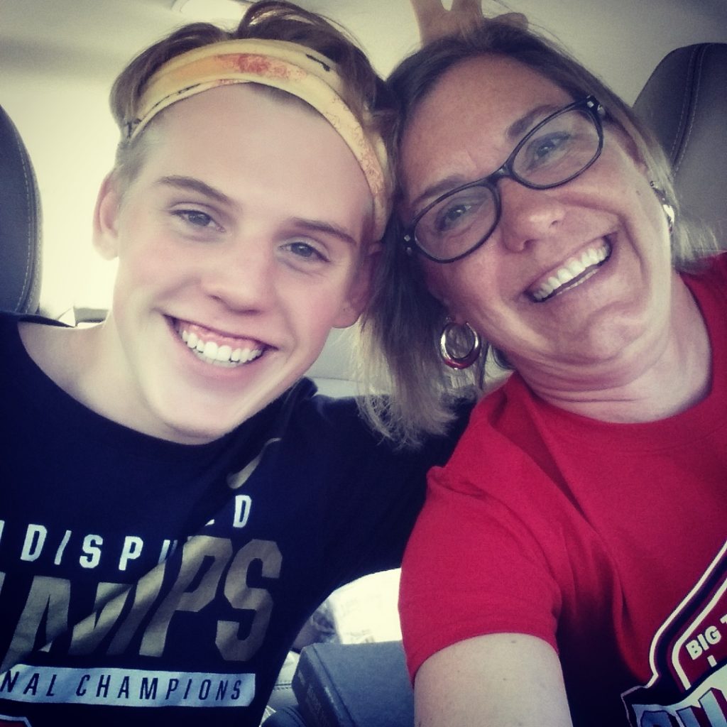 Mother and son, smiling on a road trip.