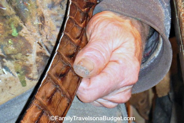 An artisan working on a hand made leather belt.