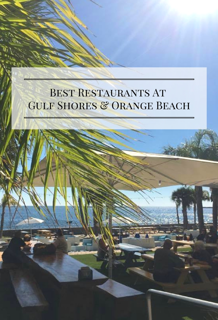 Outdoor dining with umbrellas, tables and ocean.