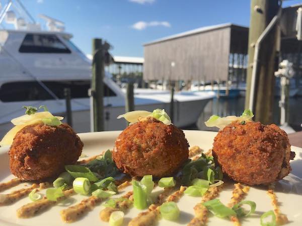 Boudin balls at Fisher's Dockside restaurant with marina in background.