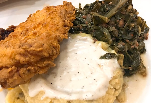 Nashville hot chicken with potatoes and collards.