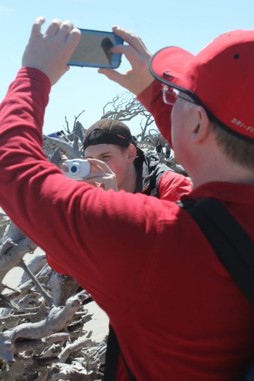 Driftwood Beach photography: Taking a photo of the men taking photos of the trees