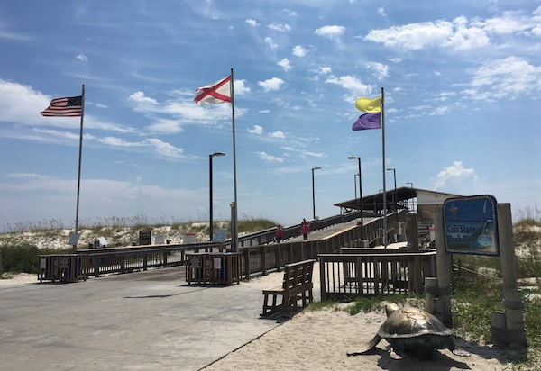 Photo of the flags at the entrance to the Gulf State Park Pier