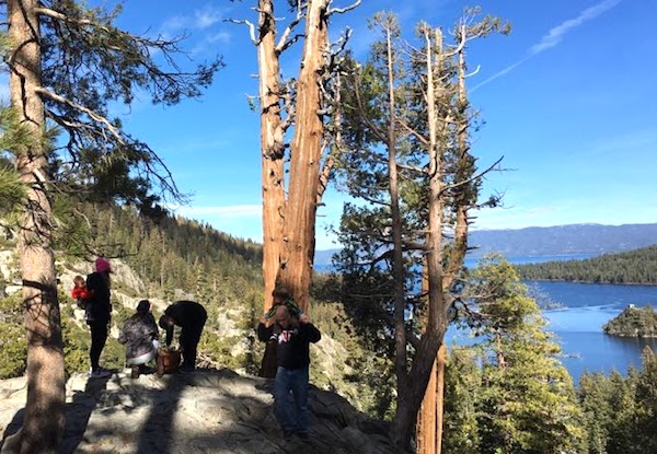 Lake Tahoe in the disstance with a group of hikers in the foreground.
