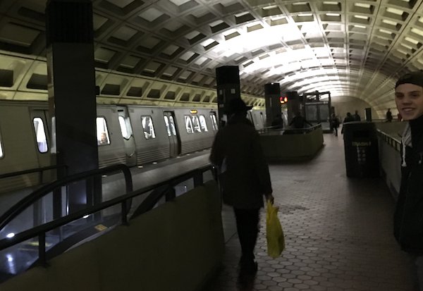 Right side of image shows my son smiling at the camera as he waits for the DC Metro after finding it on his own.