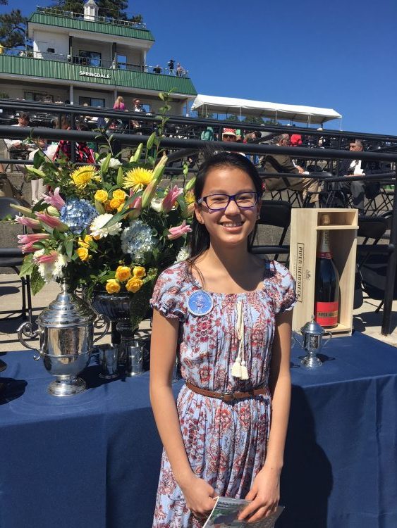 Posing in her Carolina Cup outfit in front of the trophies ner the grandstands.