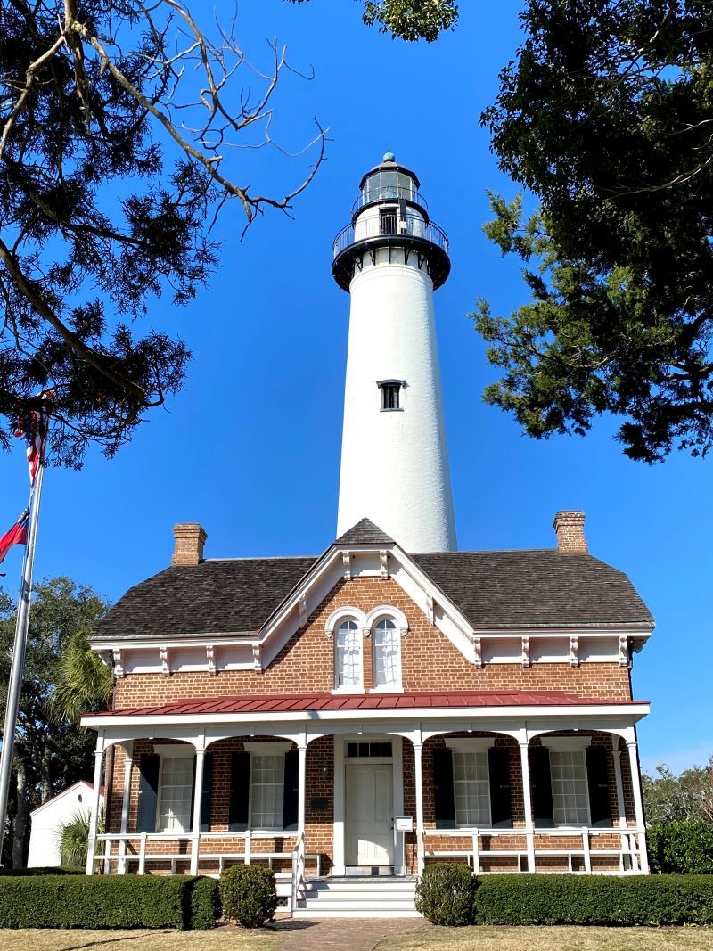 Saint Simons Island Lighthouse with the lightkeeper's house in the forefront and lighthouse behind