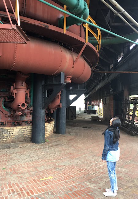 Young girl looking up at Sloss Furnaces