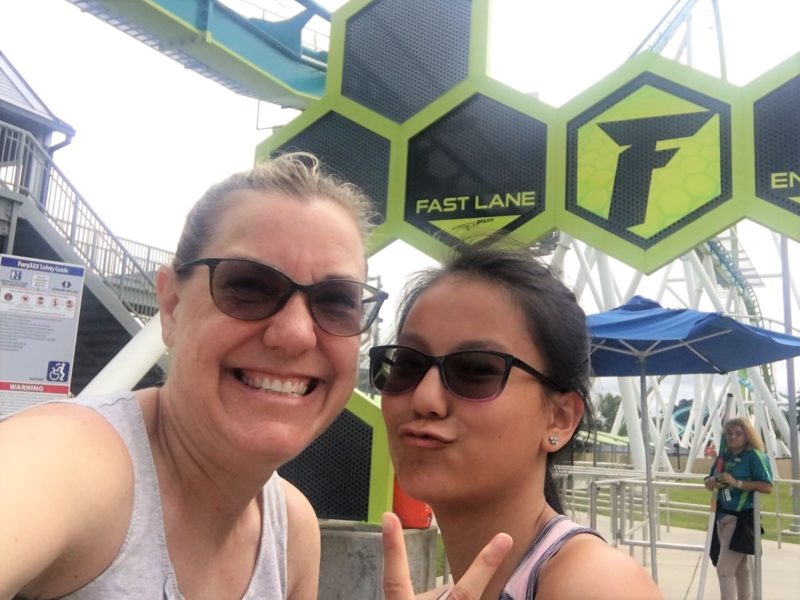 In front of the fast lane pass at Fury 325 at Carowinds theme park for teens