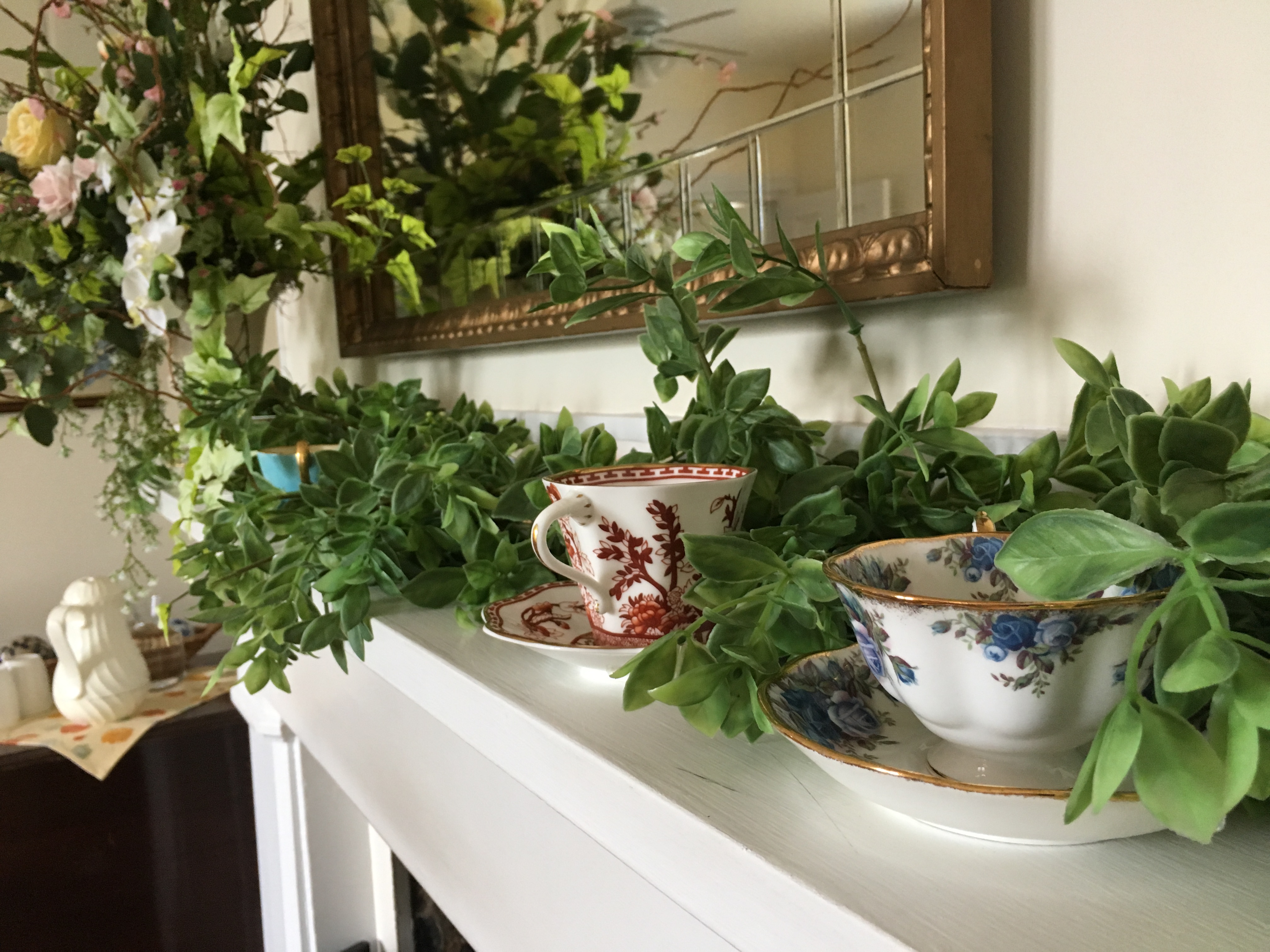 Fireplace mantle with tea cups at the Rosemont Inn Bed and Breakfast