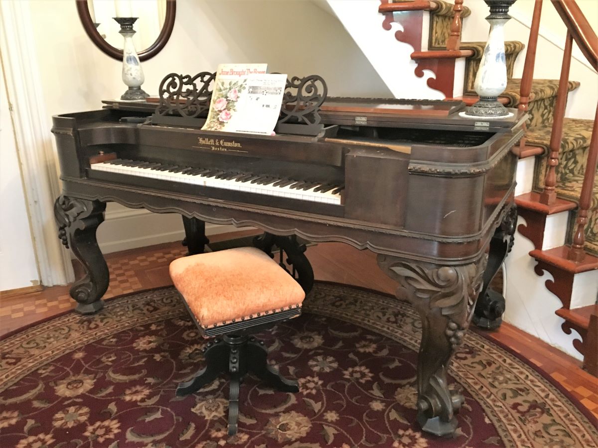 Antique piano in the foyer by the grand staircase