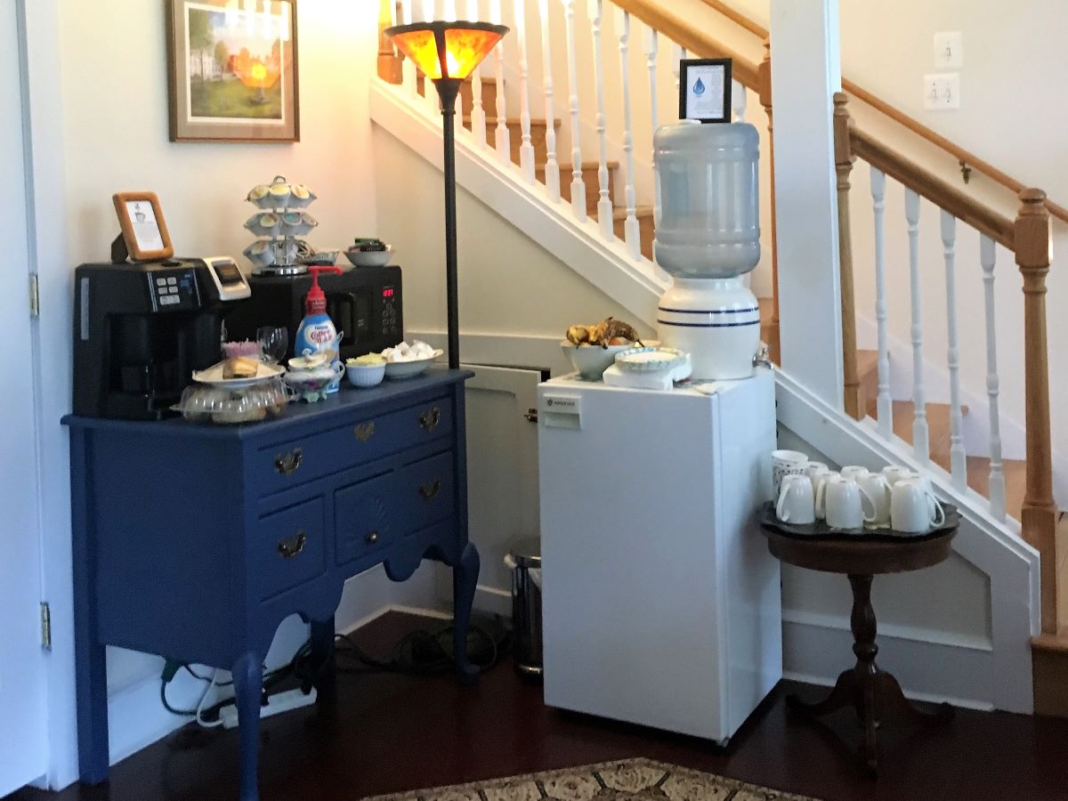 Hospitality station has coffee, water, snacks and a refrigerator for guest use