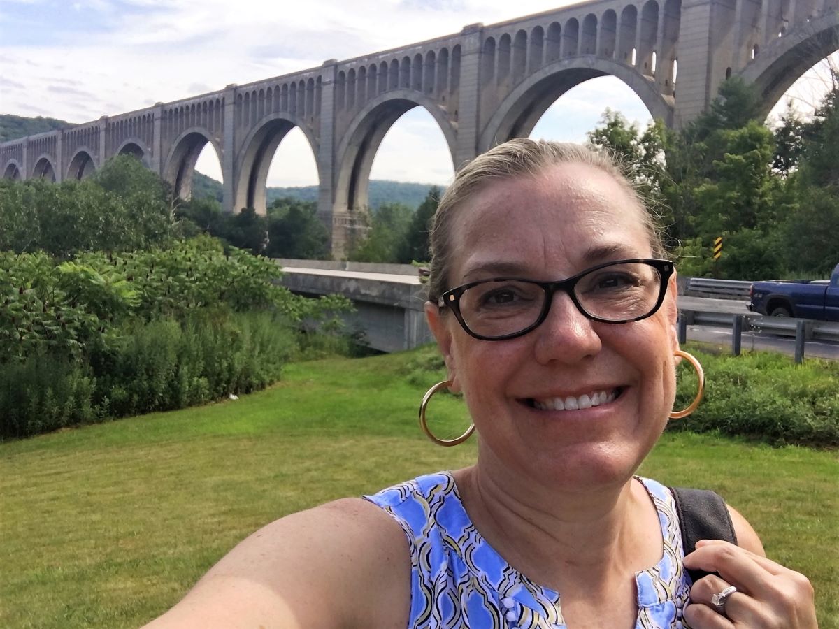 Lady standing in front of Tunkhannock Creek Viaduct in Nicholson, Pennsylvania.