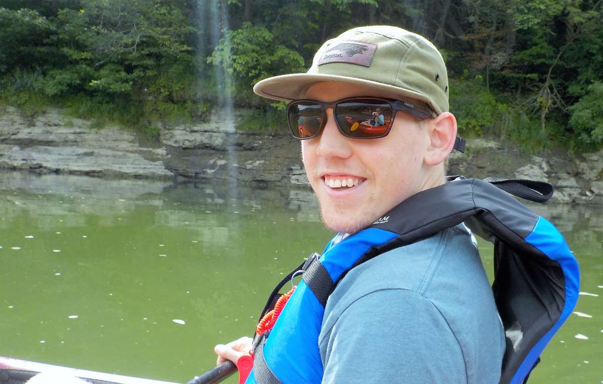 Kayaker on the Susquehanna River with sunglasses, a baseball cap and a lifejacket.