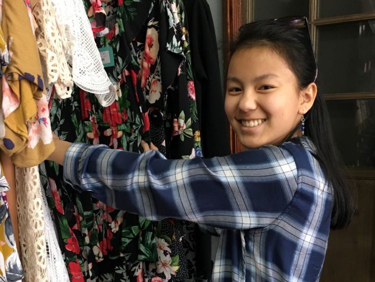 Teen posing for a photo while shopping for new clothes.