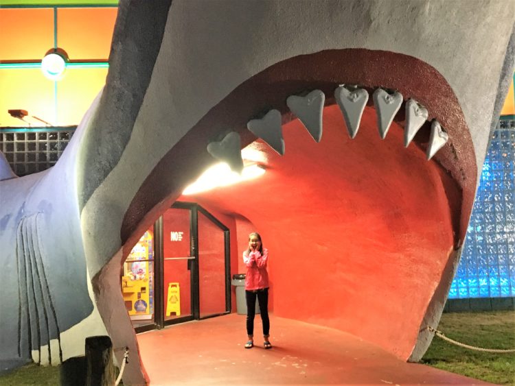 Standing in the "mouth" of a fiberglass shark entrance to a souvenir shop.