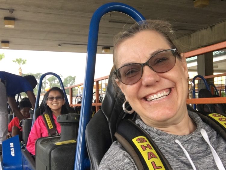 Mother and daughter with big smiles in go karts.