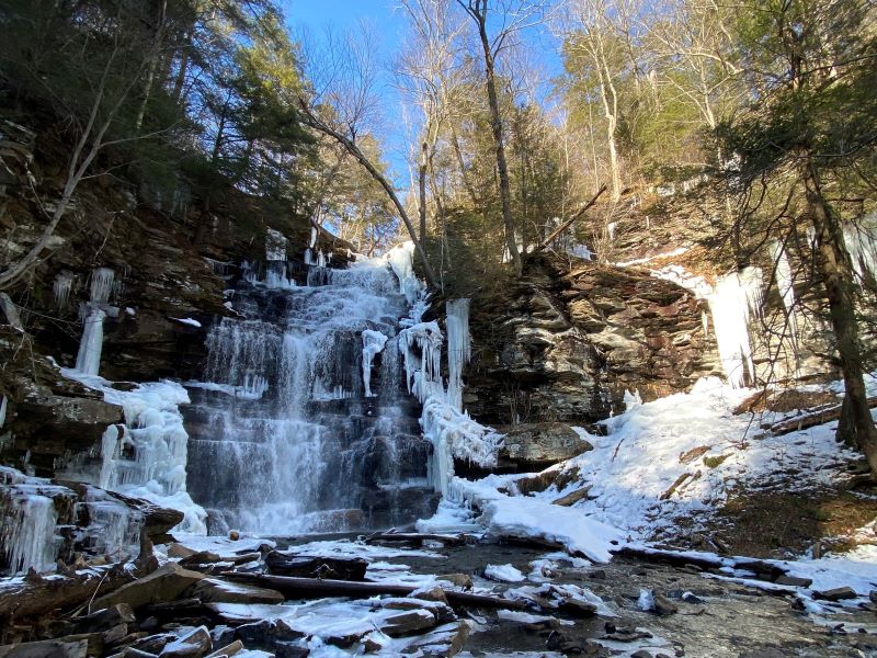 Looking up at frozen waterfalls from below.