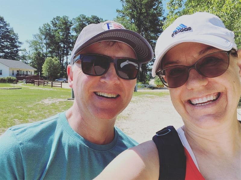 Two people in sunglasses and hats smiling at Carver Creek Park