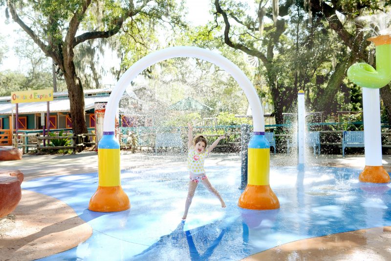 child playing in splash pad at park in Tampa, Florida.