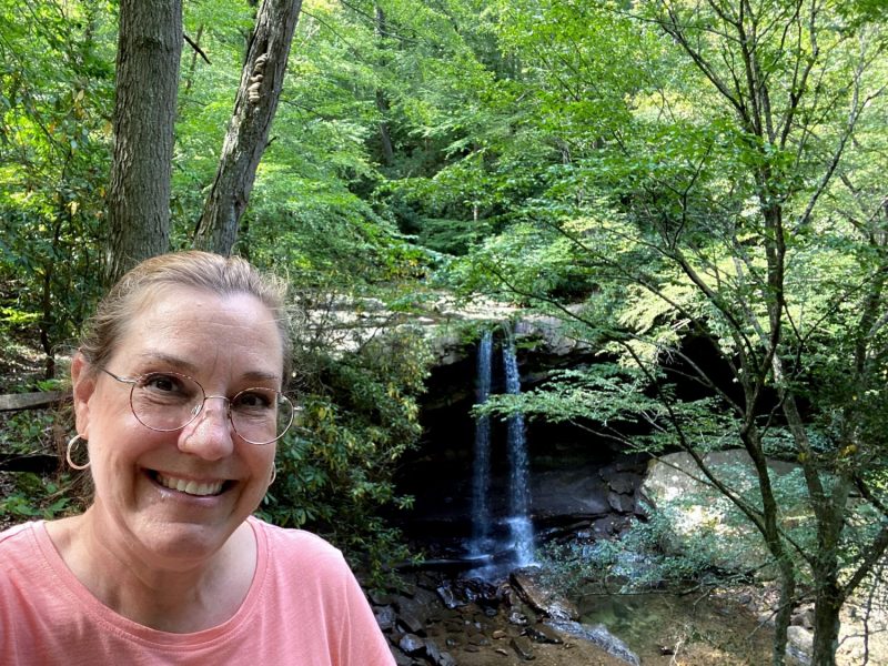 Standing at Cucumber Falls at Ohiopyle State Park, one of the best state parks in PA