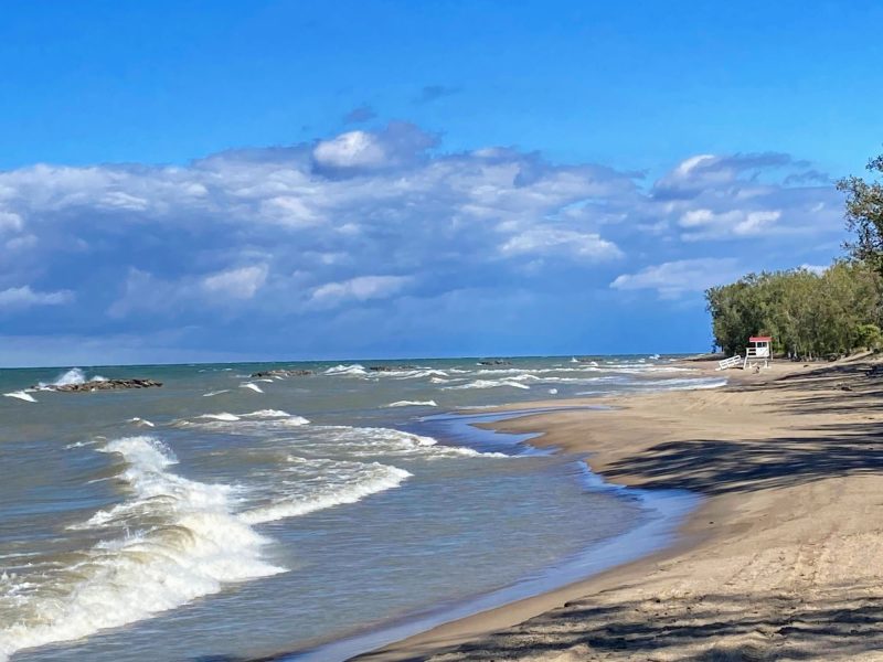 Presque Isle beach in Erie, PA with a lifeguard stand in the distance.