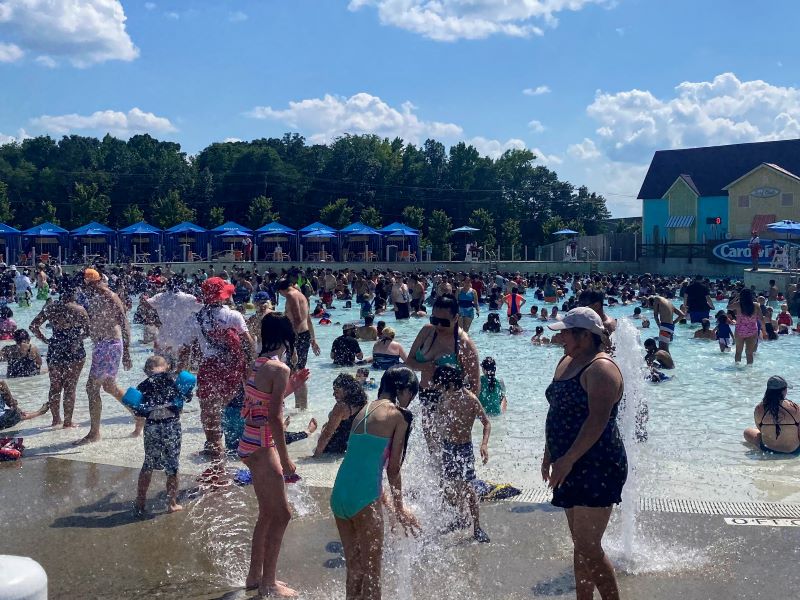 Carolina Harbor wave pool with guests playing in the water and cabanas in the background
