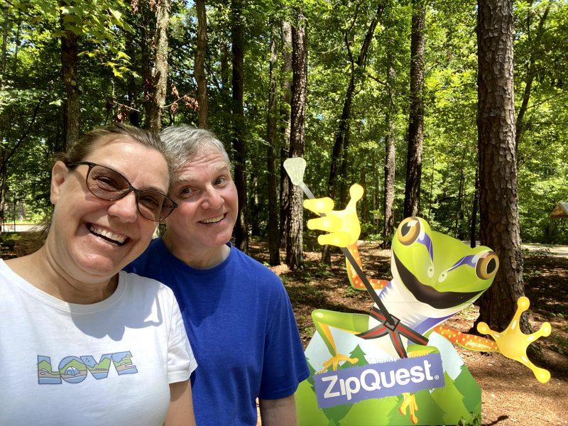 Zipquest is a fun day adventure in Fayetteville, photo of us after our zipline tour with their frog mascot.