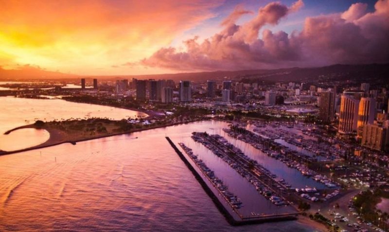 Sunset from sky view of Waikiki in purples, oranges and yellows