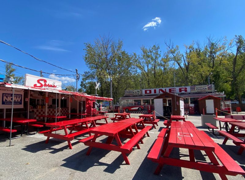 Red picnic tables at Sara's Diner, the best for family dining in Erie, PA. Iconic 1950s decor.
