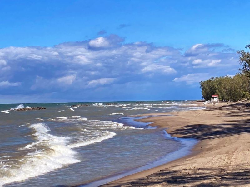 Beach at Presque Isle State Park in Erie, PA. Shows life guard stand, sandy beach and surf.