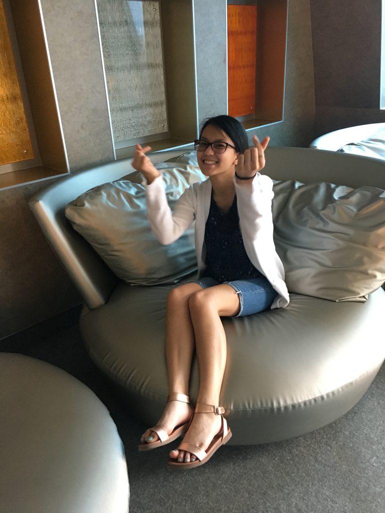 Teenager sitting on a lounge chair in the Teen Club on Celebrity Equinox