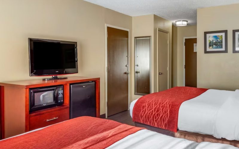 Hotels on Carowinds Blvd include the basic amenities Comfort Inn at the Park, with two queen beds, microwave and refrigerator as pictured. This photo shows a connecting door between two rooms as well.