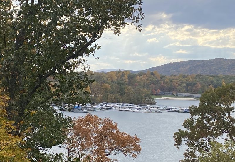 Mountains with fall leaves surrounding boats at the marina at Lake Raystown Resort