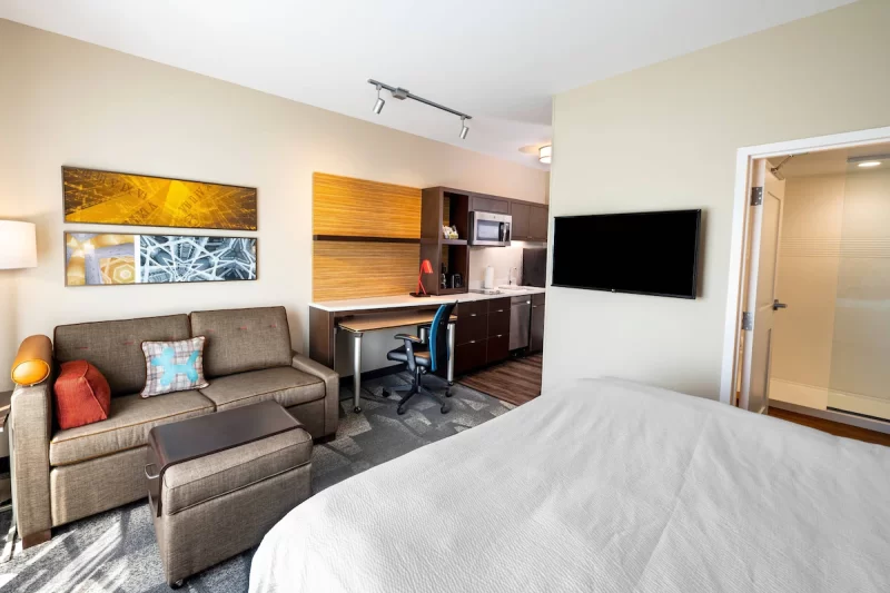 Efficiency suite at the TownPlace Suites, with sofabed, bed, kitchen area and large bathroom visible in image. One of the hotels on Carowinds Blvd