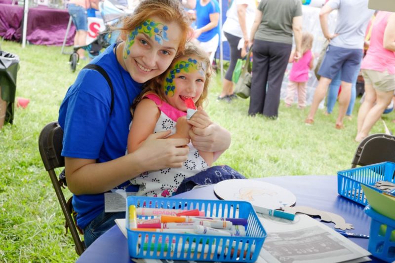 Blueberry festival in the Lehigh Valley. Photo shows woman and girl with face paint at a festival tent.
