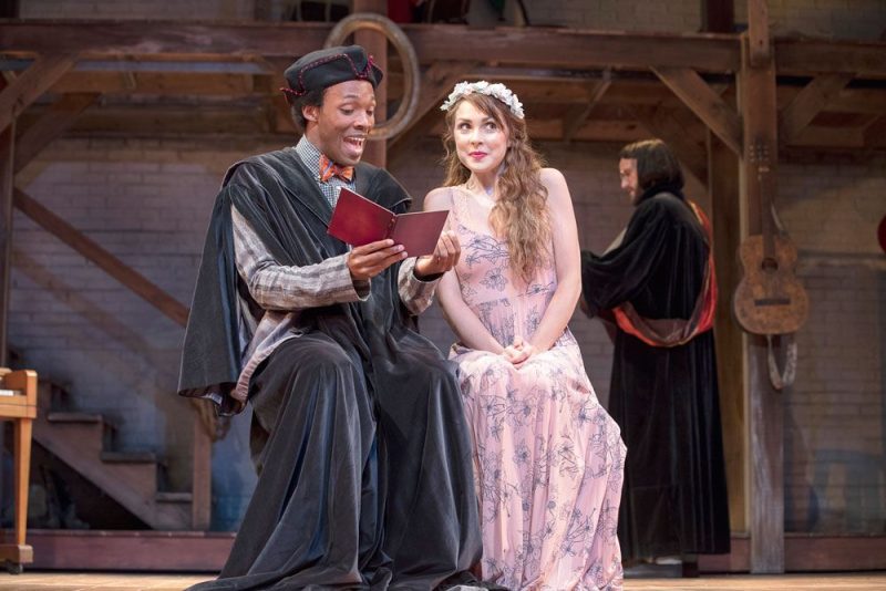 Taming of the Shrew shows two actors on stage with a third in the background at the PA Shakespeare Festival.