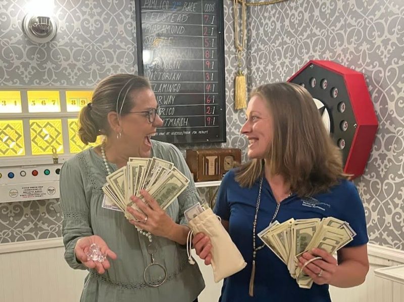 Surprised faces on two ladies who solved the escape room riddles.