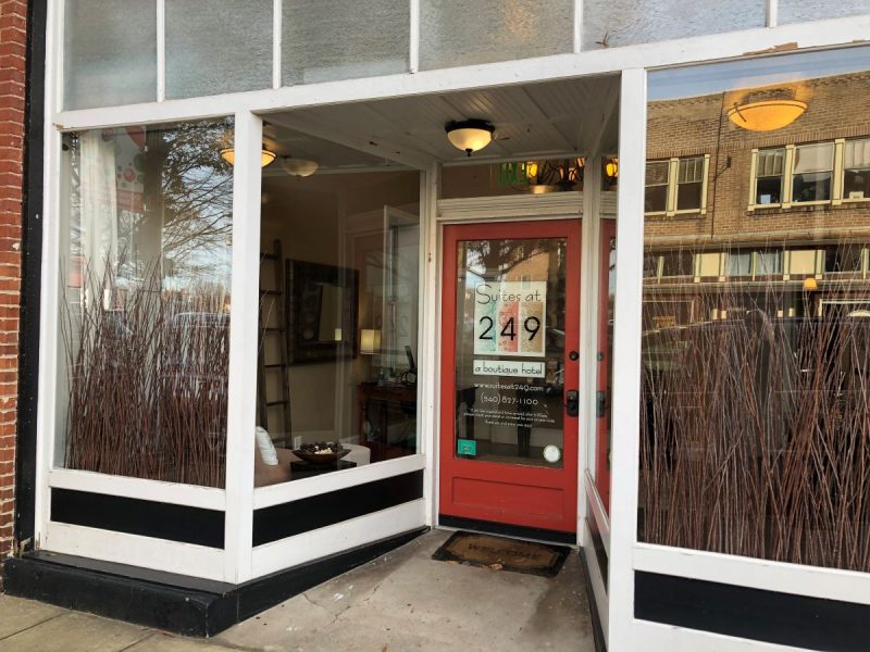 Entrance to the Suites at 249 boutique hotels in Culpeper, VA. Shows the red door with keypad and window storefront for the lobby