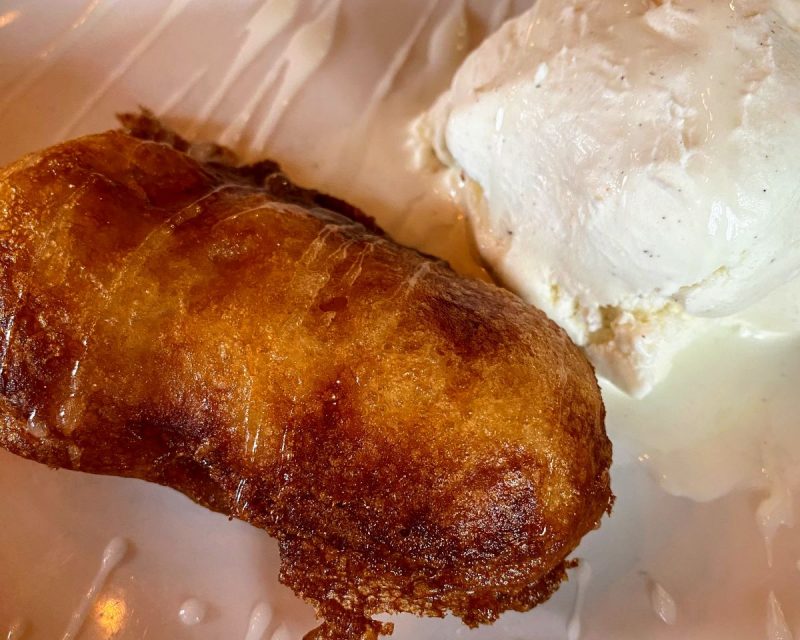 Deep fried twinkie with vanilla bean ice cream and a drizzle of sauce