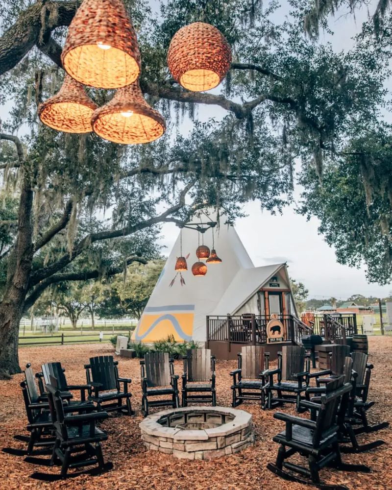 Westgate River Ranch glamping site, with fire pit and lighting hanging from a tree. A creative option for family camping in Florida