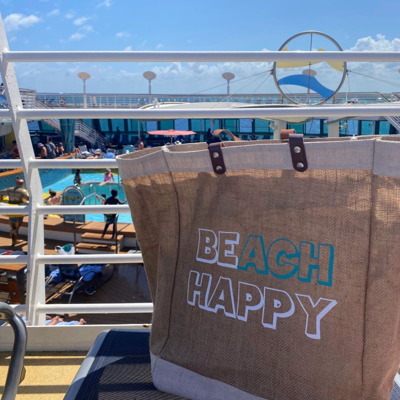 "Beach Happy" beach bag with leaether handles is a good item to add to a cruise packing list